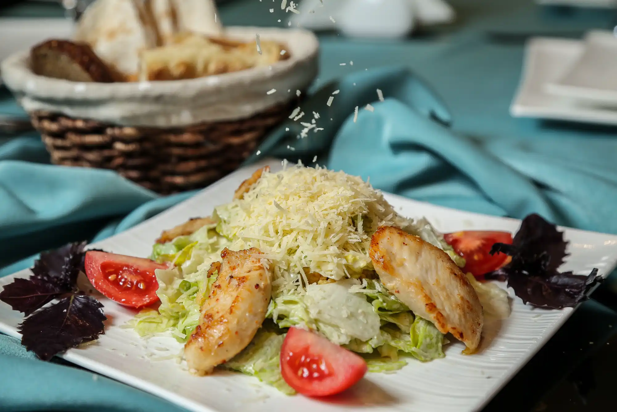 Cezar salata sa svježom piletinom, parmezanom, i paradajzom, ukusna i zdrava obrok salata.